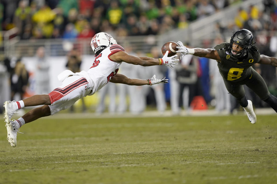 Oregon safety Jevon Holland (8) breaks up a pass for Utah wide receiver Jaylen Dixon (25) during the first half of the Pac-12 Conference championship NCAA college football game in Santa Clara, Calif., Friday, Dec. 6, 2018. (AP Photo/Tony Avelar)