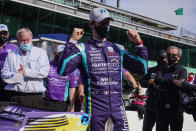 Romain Grosjean, of Switzerland, celebrates after winning the pole during qualifications for the IndyCar auto race at Indianapolis Motor Speedway in Indianapolis, Friday, May 14, 2021. (AP Photo/Michael Conroy)