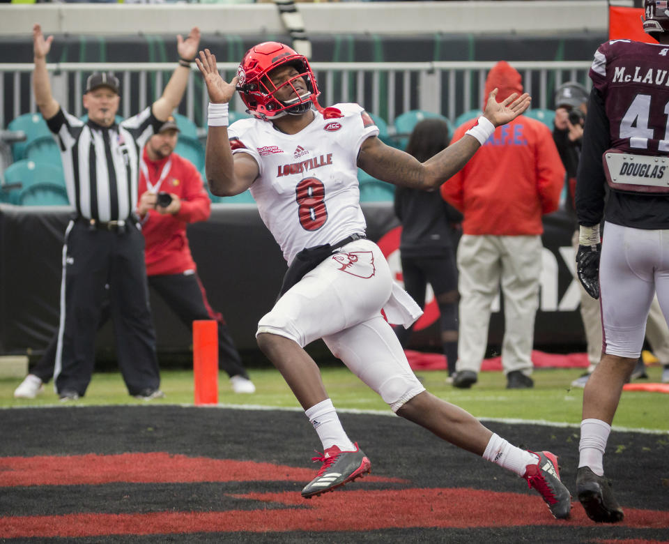 Louisville quarterback Lamar Jackson (8) celebrates a touchdown during the first half of the TaxSlayer Bowl NCAA college football game against the Mississippi State, Saturday, Dec. 30, 2017, in Jacksonville, Fla. (AP Photo/Stephen B. Morton)