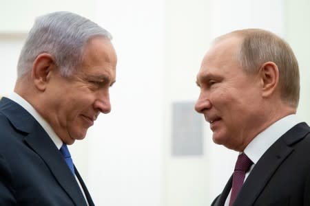 FILE PHOTO: Russian President Vladimir Putin and Israeli Prime Minister Benjamin Netanyahu greet each other during their meeting in the Kremlin in Moscow