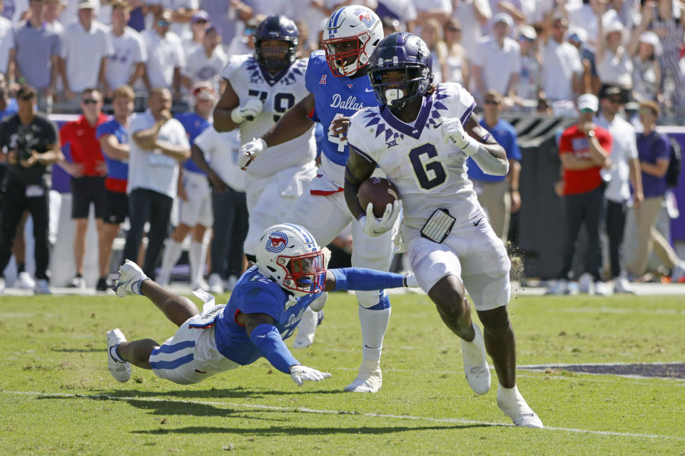 SMU safety Isaiah Nwokobia (12) lunges at TCU running back Zach Evans (6) as he runs for a touchdown during the first half of an NCAA football game in Fort Worth, Texas, Saturday, Sept. 25, 2021. (AP Photo/Michael Ainsworth)