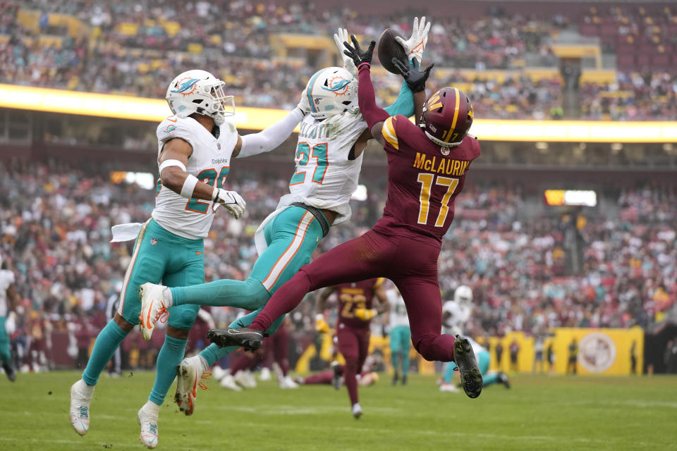Washington Commanders wide receiver Terry McLaurin (17) cannot catch a pass while being defended by Miami Dolphins safety Brandon Jones, left, and safety DeShon Elliott (21) during the second half of an NFL football game Sunday, Dec. 3, 2023, in Landover, Md. (AP Photo/Alex Brandon)