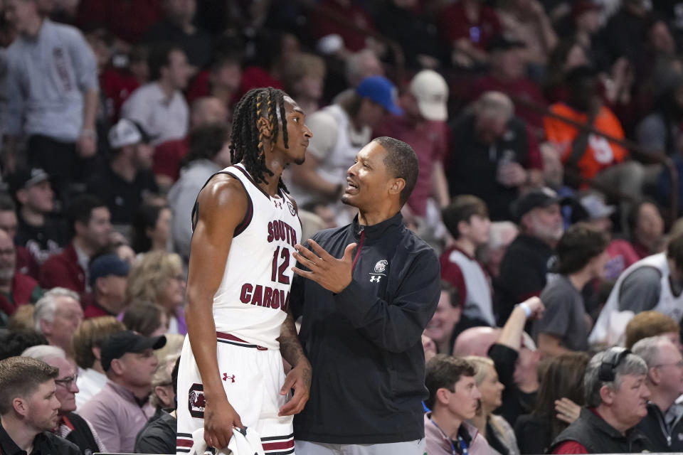 South Carolina head coach Lamont Paris talks with guard Zachary Davis (12) during a time out during the second half of an NCAA college basketball game against Vanderbilt, Saturday, Feb. 10, 2024, in Columbia, S.C. (AP Photo/David Yeazell)