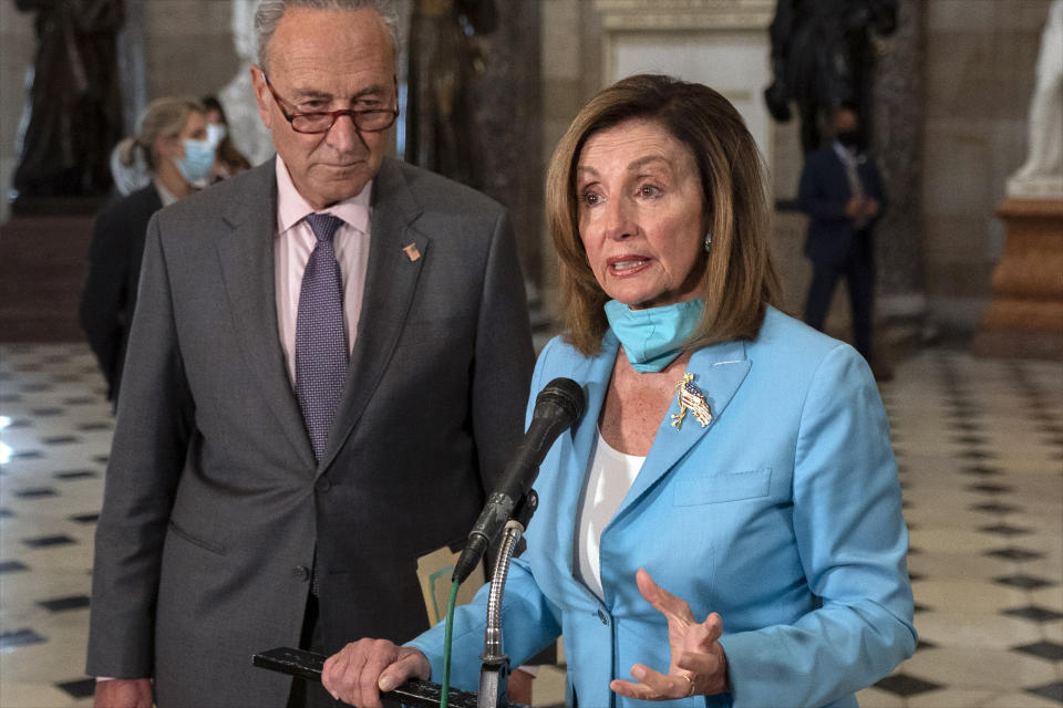 House Speaker Nancy Pelosi of Calif., joined by Senate Minority Leader Sen. Chuck Schumer of N.Y., speaks to media on Capitol Hill in Washington, Wednesday, Aug. 5, 2020. Some clarity is beginning to emerge from the bipartisan Washington talks on a huge COVID-19 response bill. An exchange of offers and meeting devoted to the Postal Service on Wednesday indicates the White House is moving slightly in House Speaker Nancy Pelosi's direction on issues like aid to states and local governments and unemployment insurance benefits. But the negotiations have a long ways to go. (AP Photo/Carolyn Kaster)