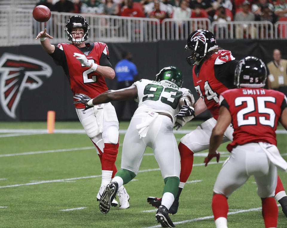 Atlanta Falcons quarterback Matt Ryan dumps off a pass to running back Ito Smith under pressure from New York Jets linebacker Tarell Basham during the first quarter of an NFL football preseason game Thursday, Aug. 15, 2019, in Atlanta. (Curtis Compton/Atlanta Journal Constitution via AP)