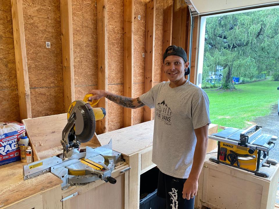 Danny and Kelley Diatchenko, co-owners of custom van and camper conversion business, VaVaVans, showing off their workspace in their home garage, located in Taunton.