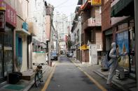 An employee from a disinfection service company sanitizes a traditional market in Seoul