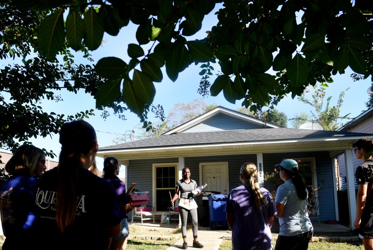 Fuller Center for Housing of Northwest Louisiana's Nichelle Grimes speaks to a crowd of volunteers in front of one of the center's houses on Clay Street Saturday morning, September 30, 2023.