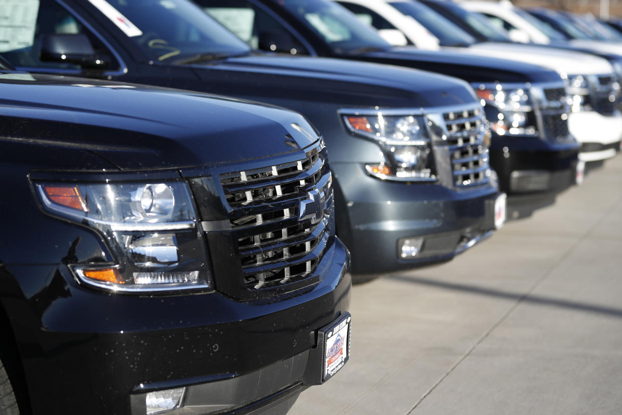 In this Sunday, Feb. 3, 2019, file photograph, a long row of unsold 2019 Suburbans sits at a Chevrolet dealership in Littleton, Colo. (AP Photo/David Zalubowski)