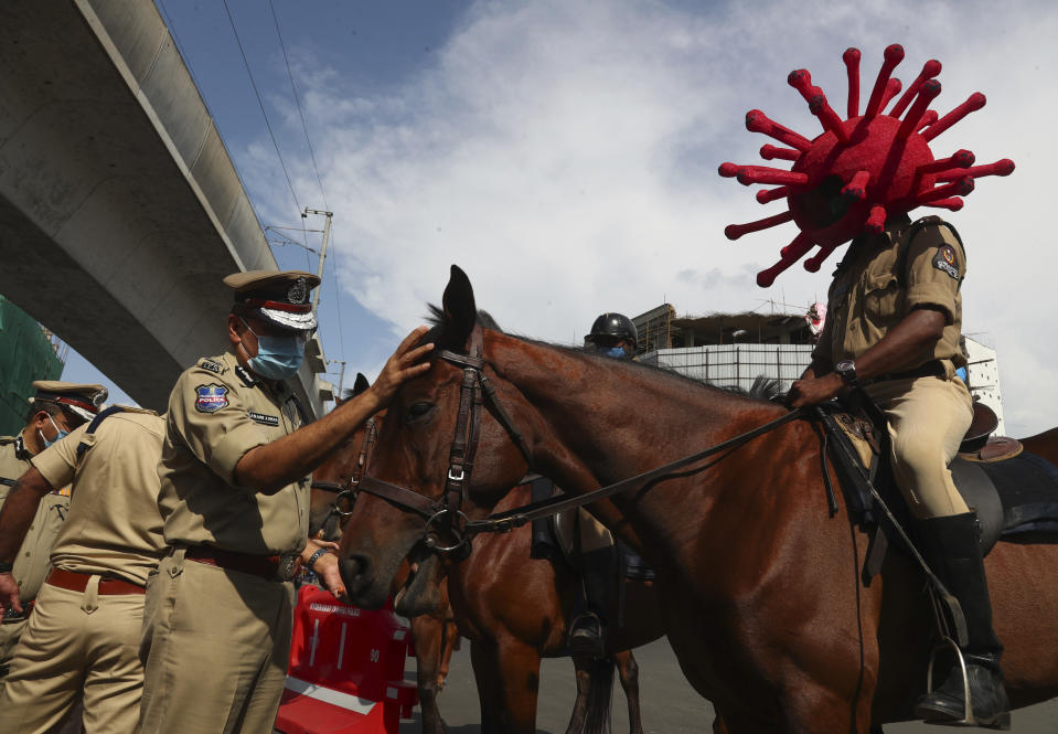 A policeman rides a horse wearing a virus-themed helmet during a COVID-19 awareness drive in Hyderabad, India, Tuesday, June 1, 2021. (AP Photo/Mahesh Kumar A.)