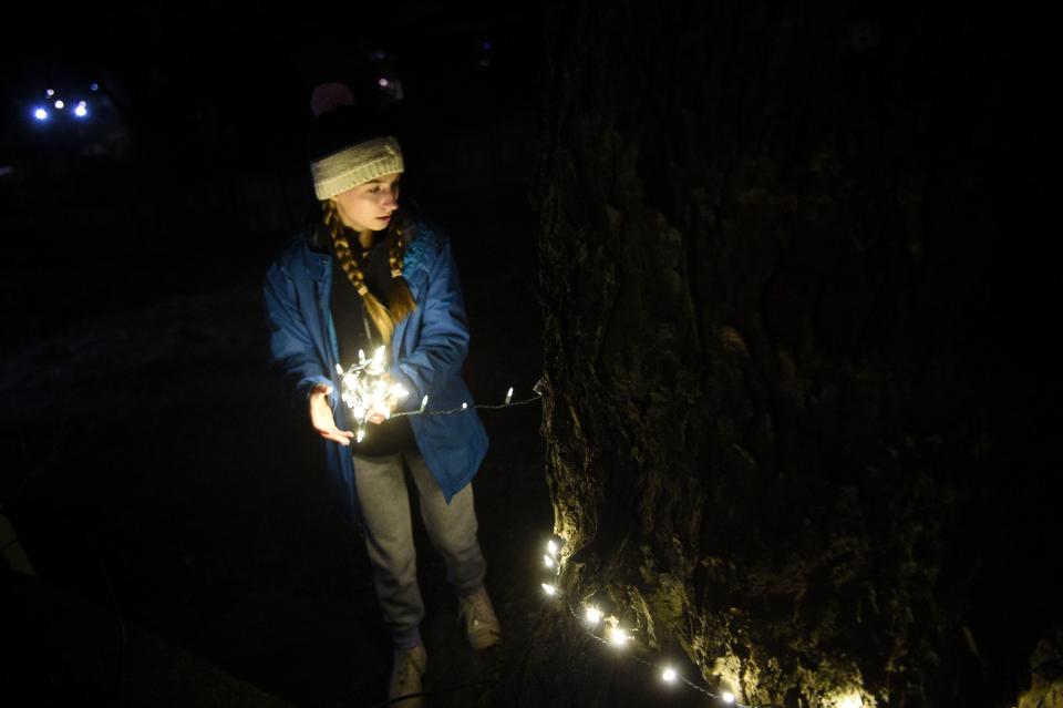 Harper Morris of Sequoyah Hills Presbyterian works on decorating a tree at the at Light Up Lonsdale in Lonsdale, Wednesday, Nov. 29, 2023.