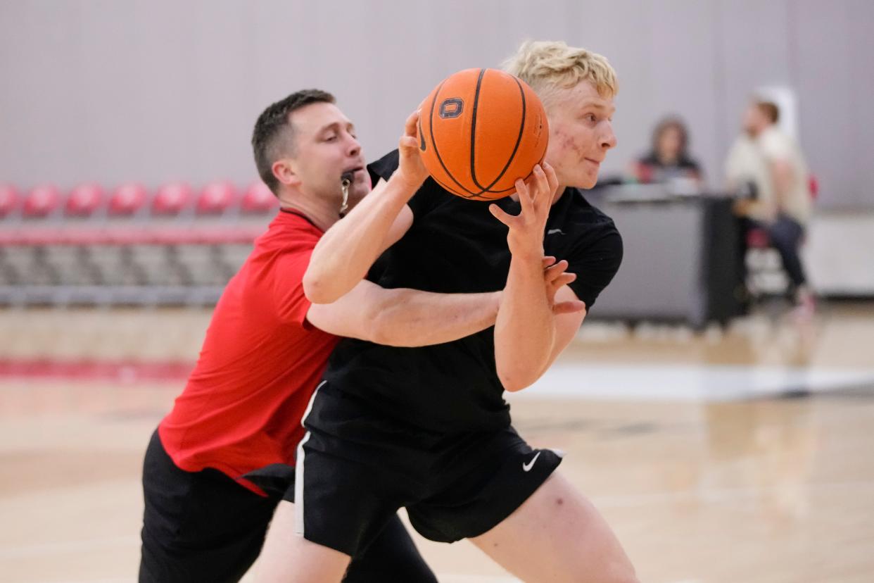 Jul 9, 2024; Columbus, OH, USA; Ohio State Buckeyes head coach Jake Diebler defends forward Colin White during a summer workout in the practice gym at the Schottenstein Center.