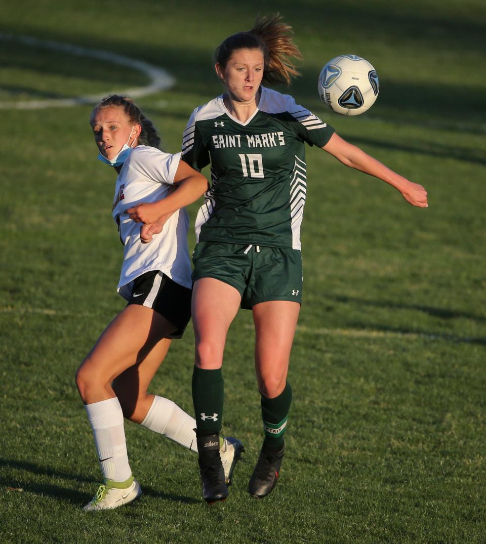 Ursuline's Sophia Filipowski (left) converges on the ball with St. Mark's Madeline Schepers in the Spartans' 6-2 win Wednesday, May 12, 2021 at St. Mark's High School.