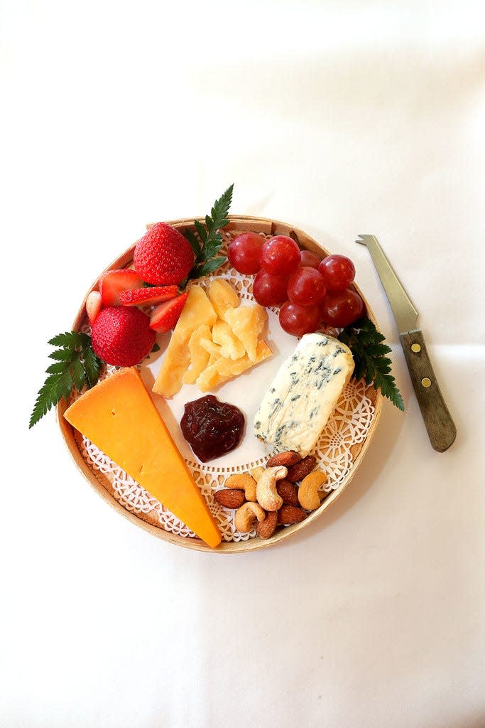 A variety of cheeses, fruit and more can make for a simple appetizer for guests to nibble on during the Packer game on Thanksgiving.