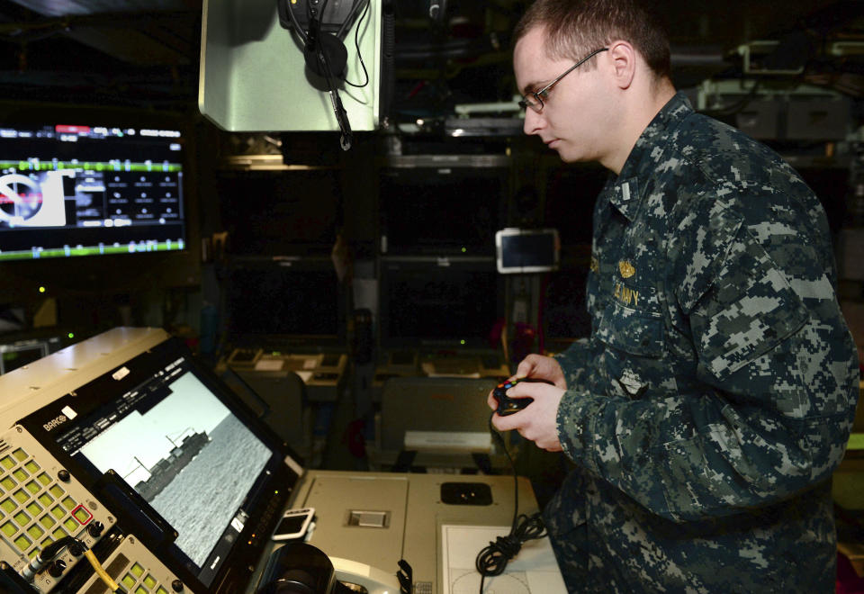 In this Feb. 2, 2018 photo released by the U.S. Navy, Lt. j.g. William Gregory uses an Xbox game controller to maneuver the photonics mast aboard the submarine scheduled to be commissioned as the USS Colorado on Saturday, March 17, 2018, in Groton, Conn. (Steven Hoskins/U.S. Navy via AP) / Credit: Steven Hoskins / AP