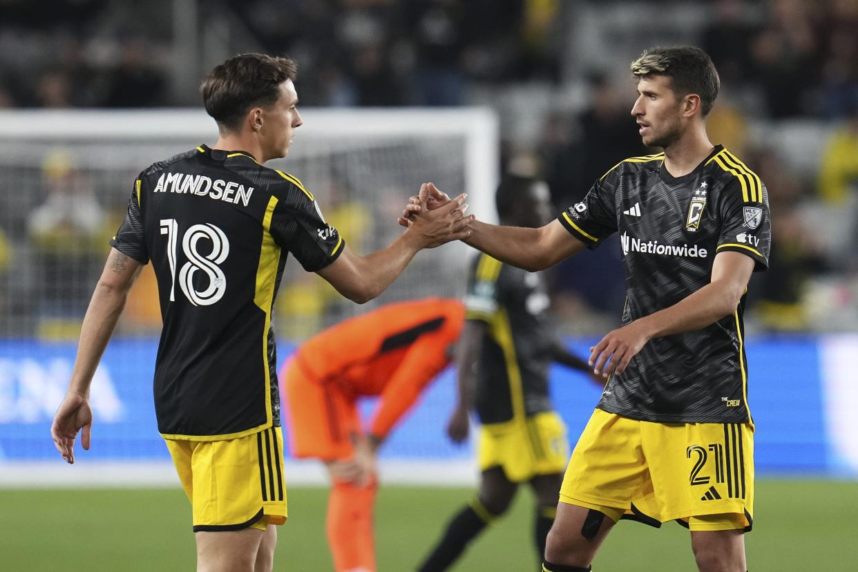 Mar 12, 2024; Columbus, OH, USA; Columbus Crew defender Malte Amundsen (18) celebrates the win with defender Yevhen Cheberko (21) following the Concacaf Champions Cup soccer game against the Houston Dynamo at Lower.com Field. Mandatory Credit: Adam Cairns-USA TODAY Sports