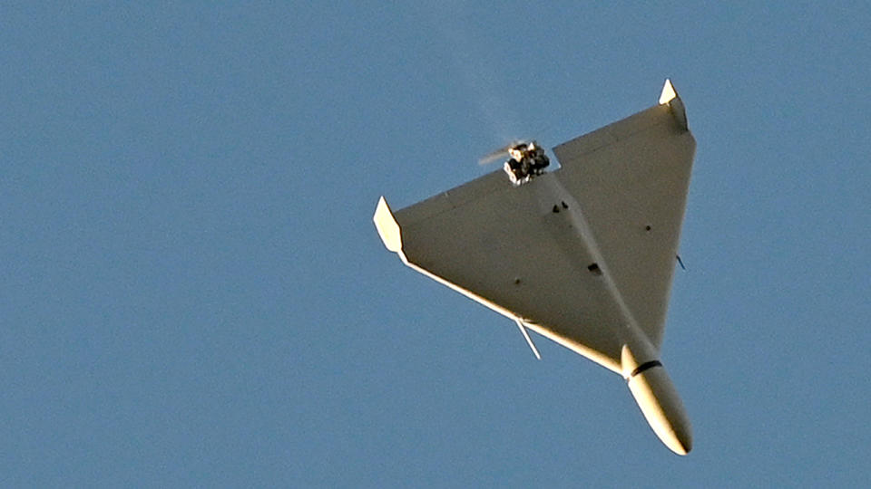 A view of the underside of a drone in flight. 