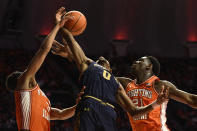 Notre Dame's Blake Wesley (0) Illinois' Kofi Cockburn (21) and Illinois' Jacob Grandison vie for a rebound during the first half of an NCAA college basketball game Monday, Nov. 29, 2021, in Champaign, Ill. (AP Photo/Michael Allio)