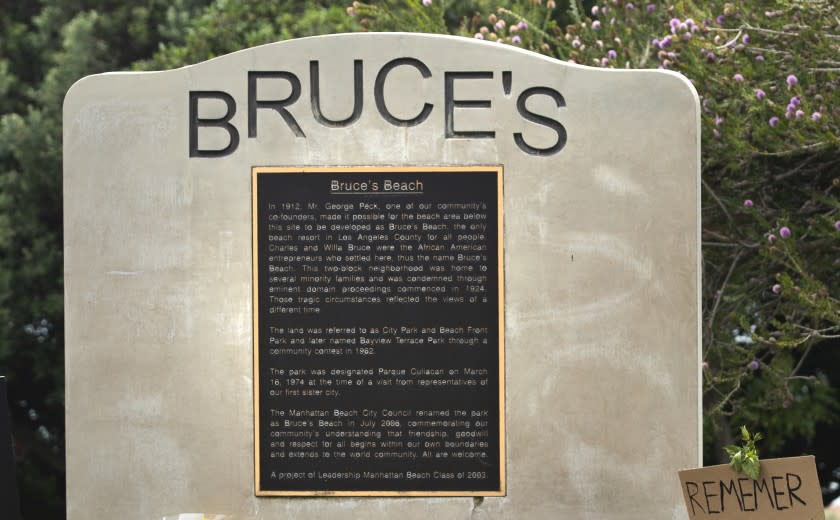MANHATTAN BEACH, CA -JULY 29, 2020: A commemorative plaque at Bruce's Beach, a park located in Manhattan Beach, explains the history of the area. Bruce's Beach used to be owned by one of the first prominent Black oceanfront homeowners (in the 1920's) but Manhattan Beach ran them out of town and erased/rewrote the history of what happened. A new generation of residents are now calling on the city to confront its racist past. Many have reclaimed the space in recent weeks to celebrate and honor the Black Lives Matter movement. (Mel Melcon / Los Angeles Times)