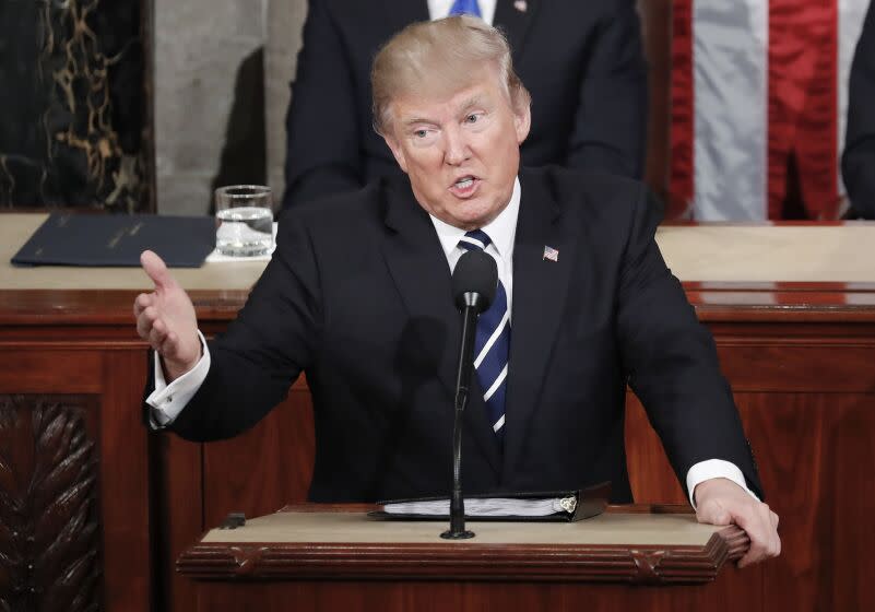 President Donald Trump gestures towards democrats while addressing a joint session of Congress on Capitol Hill