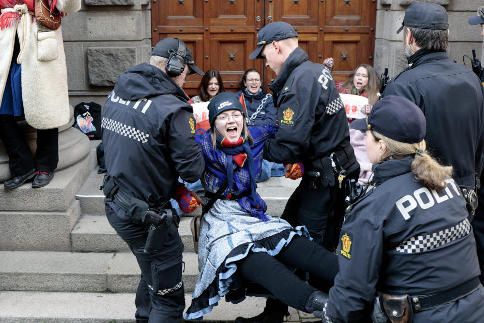 Activists are carried away by the police during a protest against a wind farm they say hinders the rights of the Sami Indigenous people to raise reindeer in Arctic Norway, in Oslo, Thursday, March 2, 2023. (Alf Simensen/NTB Scanpix via AP)