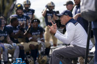 Gallaudet head coach Chuck Goldstein, right, uses American Sign Language to communicate with players during an NCAA college football game against Hilbert College, Saturday, Oct. 7, 2023, in Washington. (AP Photo/Stephanie Scarbrough)