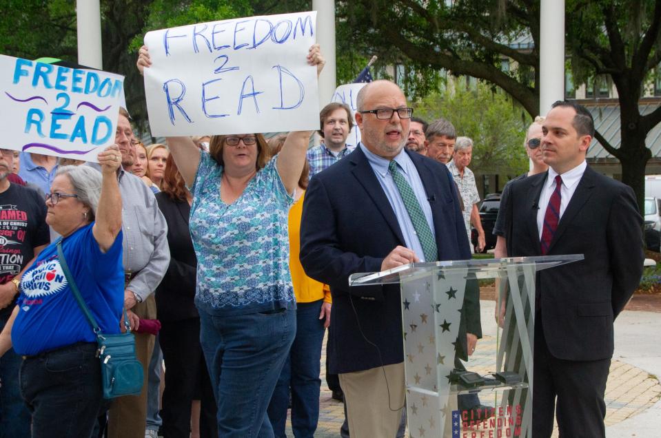 Robert Goodman, executive director of Citizens Defending Freedom, speaks Monday morning in Bartow as protestors march behind him. CDF filed a lawsuit that accuses the Polk County School Board of violating state law in his procedures for handling challenges to books in school libraries.