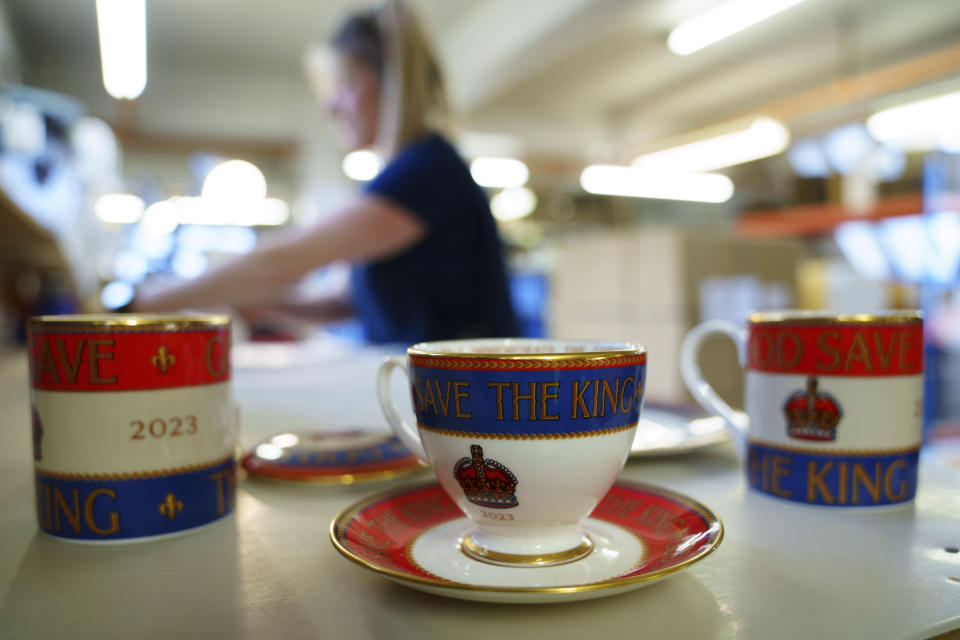 Dispatcher Steph Bogdanski packs the finished products, at the Duchess China 1888 factory, in Stoke-on-Trent, England, Thursday, March 30, 2023. With just five weeks to go until King Charles III’s coronation, an historic pottery is busy producing “God Save The King” commemorative china plates and mugs to mark the occasion. (AP Photo/Jon Super)