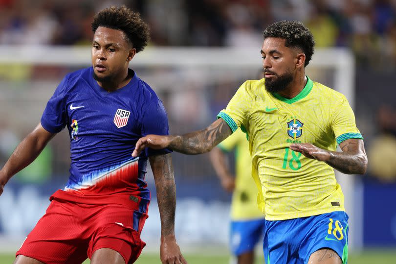 Weston McKennie #8 of the United States is marked by  Douglas Luiz #18 of Brazil