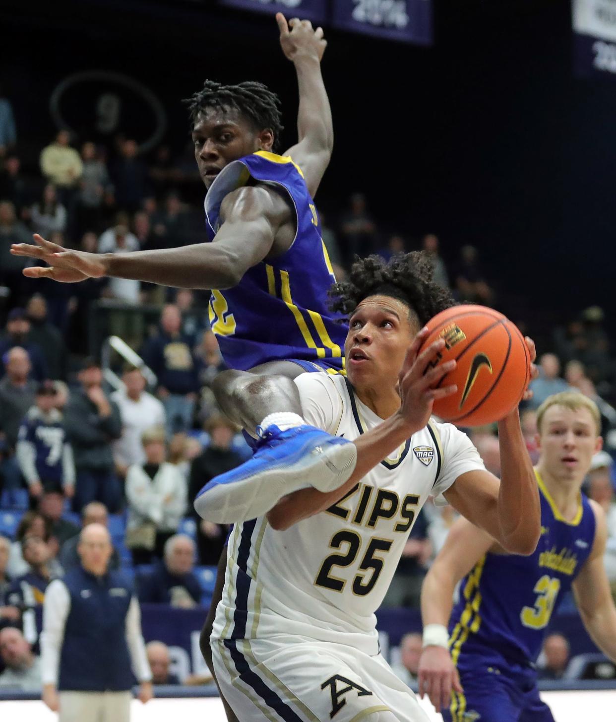 Akron forward Enrique Freeman, bottom, is fouled by South Dakota State forward Willam Kyle III during overtime, Monday, Nov. 7, 2022.