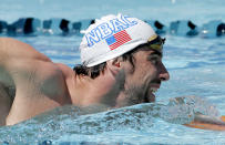 Michael Phelps warms up prior to competing in the 100-meter butterfly during the Arena Grand Prix swim meet, Thursday, April 24, 2014, in Mesa, Ariz. It is Phelps' first competitive event after a nearly two-year retirement. (AP Photo/Matt York)