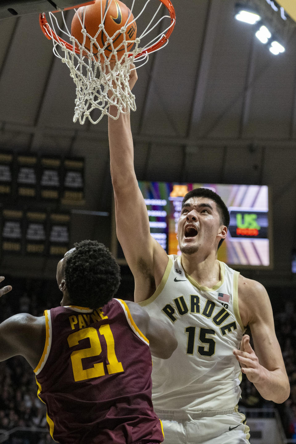 Purdue center Zach Edey (15) scores with a dunk while being defended by Minnesota forward Pharrel Payne (21) during the second half of an NCAA college basketball game, Sunday, Dec. 4, 2022, in West Lafayette, Ind. (AP Photo/Doug McSchooler)