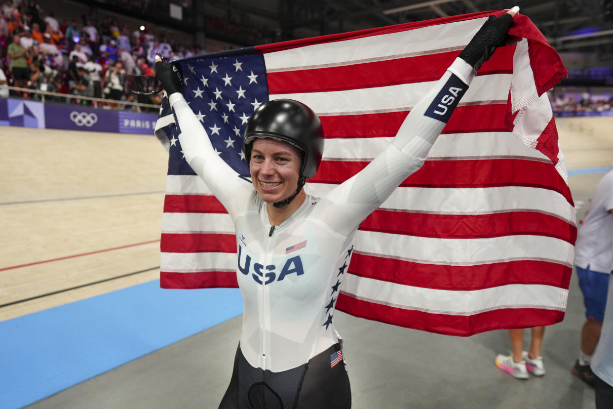 Jennifer Valente of the United States celebrates winning the gold medal of the women's omnium event, at the Summer Olympics, Sunday, Aug. 11, 2024, in Paris, France. (AP Photo/Thibault Camus)