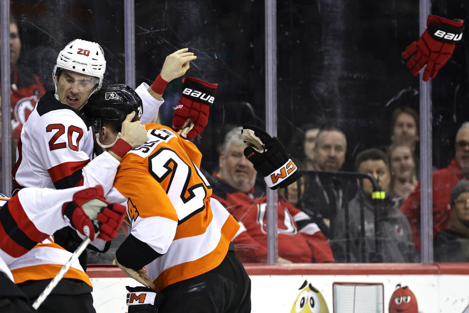 New Jersey Devils center Michael McLeod (20) fights with Philadelphia Flyers defenseman Nick Seeler during the second period of an NHL hockey game Saturday, Feb. 25, 2023, in Newark, N.J. (AP Photo/Adam Hunger)