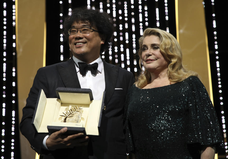 Director Bong Joon-ho, winner of the Palme d'Or award for the film 'Parasite', left, and actress Catherine Deneuve during the awards ceremony at the 72nd international film festival, Cannes, southern France, Saturday, May 25, 2019. (Photo by Vianney Le Caer/Invision/AP)