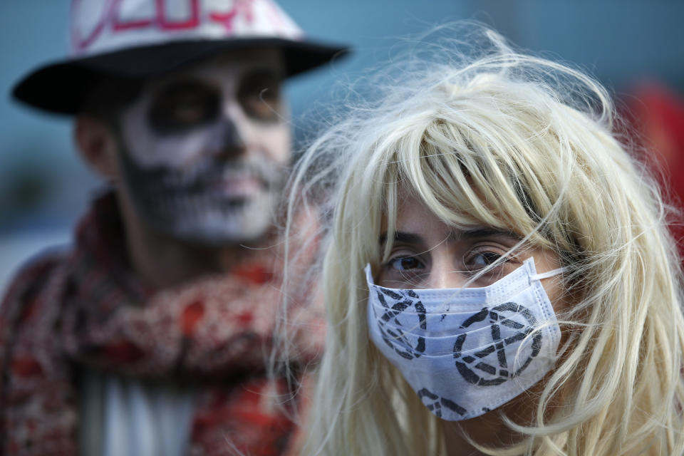 Extinction Rebellion climate change protesters call for action on climate change by staging an event against the fashion industry outside a shopping centre in Istanbul, Friday, Nov. 29, 2019. (AP Photo/Lefteris Pitarakis)