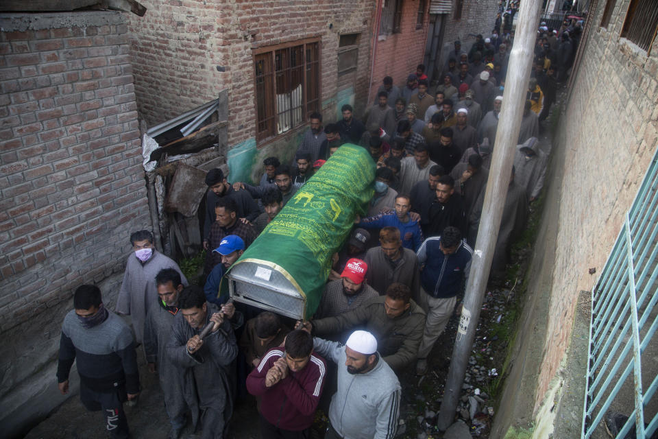 Kashmiri villagers carry the coffin of elected official Riyaz Ahmad in Sopore, 55 kilometers (34 miles) north of Srinagar, Indian controlled Kashmir, Monday, March. 29, 2021. Gunmen killed an elected official of India's ruling party and a policeman in disputed Kashmir on Monday, police said. Police blamed anti-India militants for the attack. None of the rebel groups that have been fighting against Indian rule since 1989 immediately claimed responsibility for the attack. (AP Photo/Mukhtar Khan).