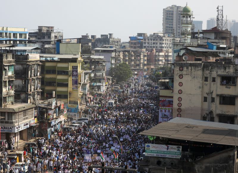 Demonstrators walk during a protest march against a new citizenship law, on the outskirts of Mumbai