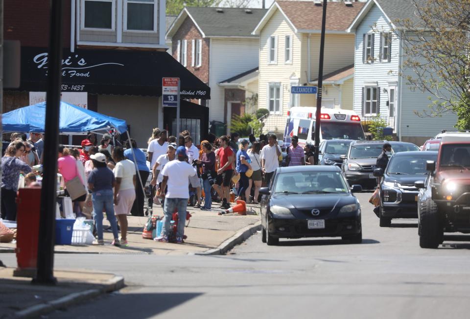 Large food donations and tables were set up at the Buffalo Community Fridge on East Ferry Street in Buffalo, NY to provide food that neighbors would have normally got at the nearby Tops Friendly Market on Jefferson Ave.  on May 15, 2022. The area was crowded with people dropping off donations and getting food.