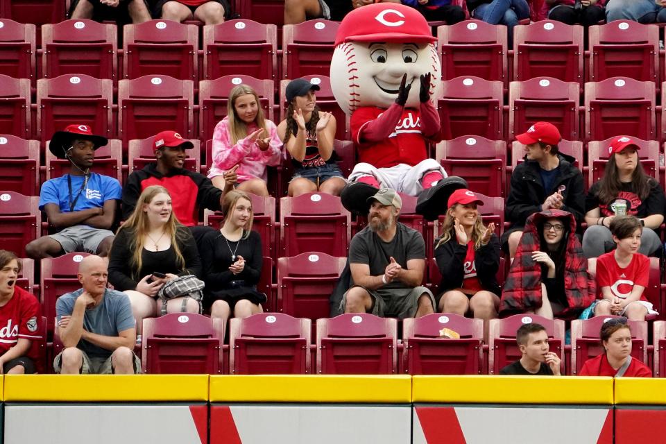 Cincinnati Reds mascot Mr. Red sits among fans in right field in the third inning of a baseball game between the Arizona Diamondbacks and the Cincinnati Reds, Monday, June 6, 2022, at Great American Ball Park in Cincinnati. 
