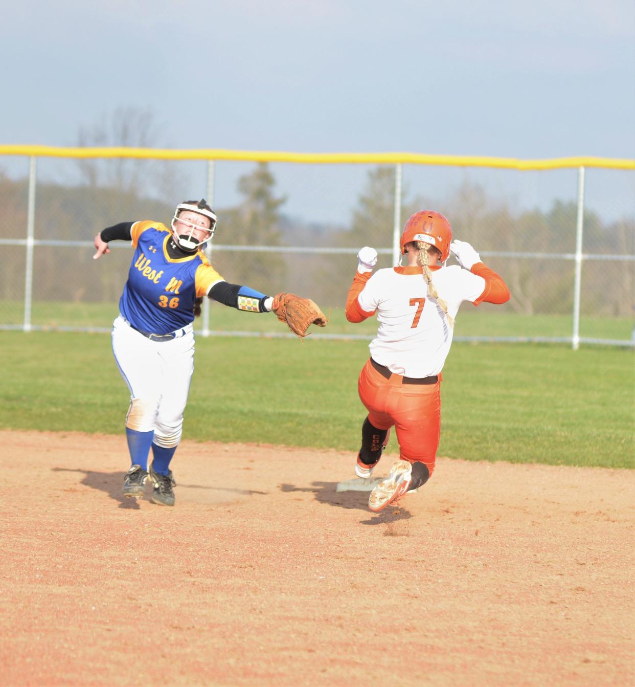 Meadowbrook's Addy Wiggins slides into second base around the tag of West Muskingum's Kadie Bare in Monday's softball game. The Tornadoes won 6-5.