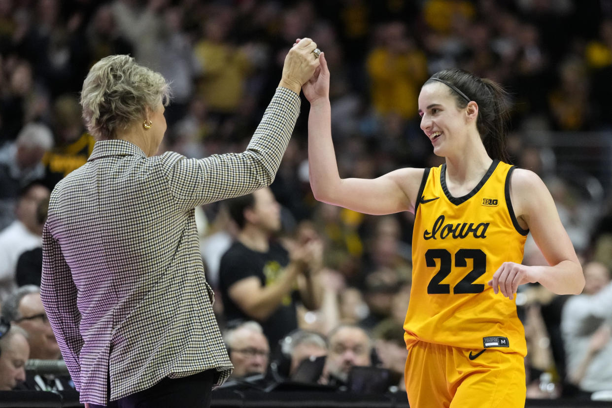 Iowa guard Caitlin Clark celebrates with head coach Lisa Bluder during a recent game. (AP Photo/Charlie Neibergall)