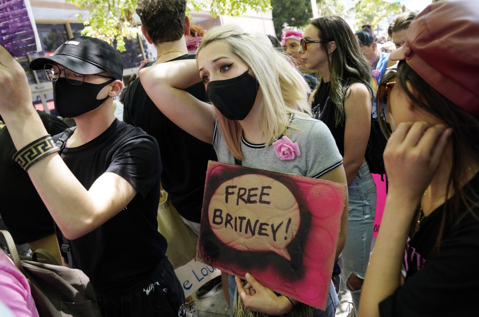 Britney Spears supporter Krista Robinson, of Los Angeles, waits to hear news outside a court hearing concerning the pop singer's conservatorship at the Stanley Mosk Courthouse, Wednesday, June 23, 2021, in Los Angeles. (AP Photo/Chris Pizzello)