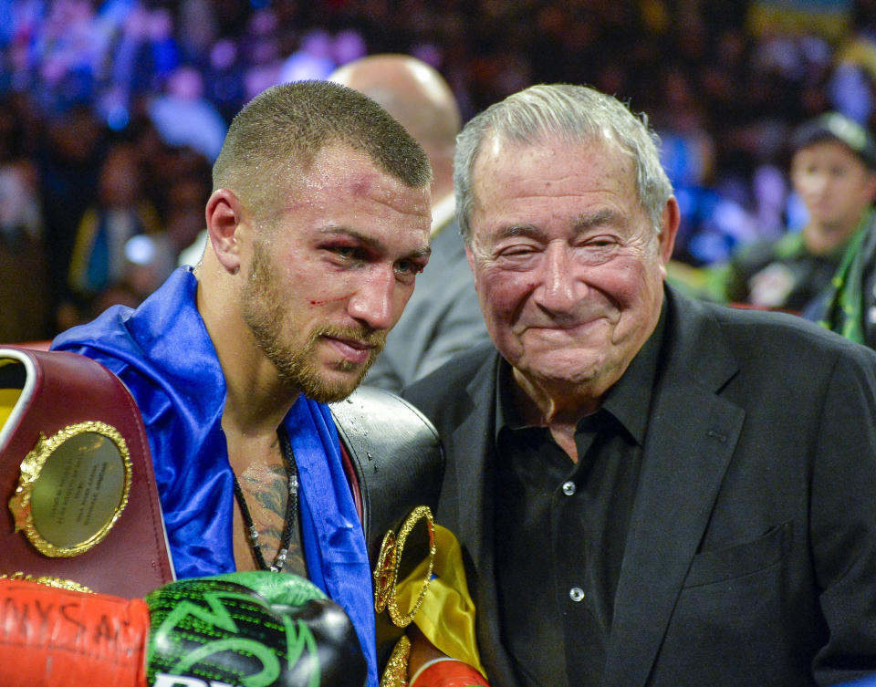 Vasiliy Lomachenko poses with promoter Bob Arum after defeating Jose Pedraza in the WBO title lightweight boxing match at Madison Square Garden, Saturday, Dec. 8, 2018, in New York. (AP Photo/Howard Simmons)