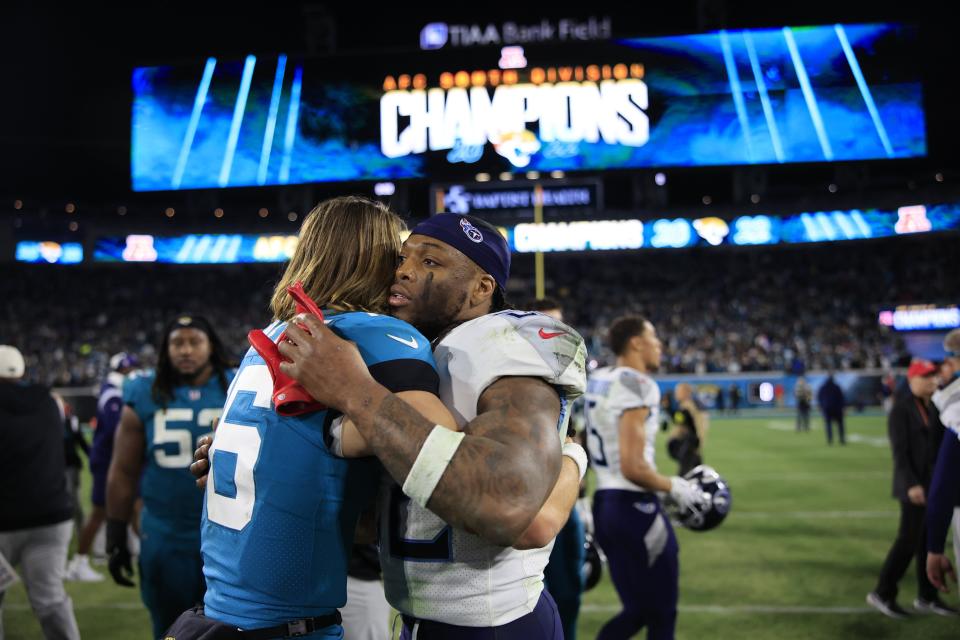 Jacksonville Jaguars quarterback Trevor Lawrence (16) hugs Tennessee Titans running back Derrick Henry (22) after the game of an NFL football regular season matchup AFC South division title game Saturday, Jan. 7, 2023 at TIAA Bank Field in Jacksonville. The Jacksonville Jaguars held off the Tennessee Titans 20-16. [Corey Perrine/Florida Times-Union]