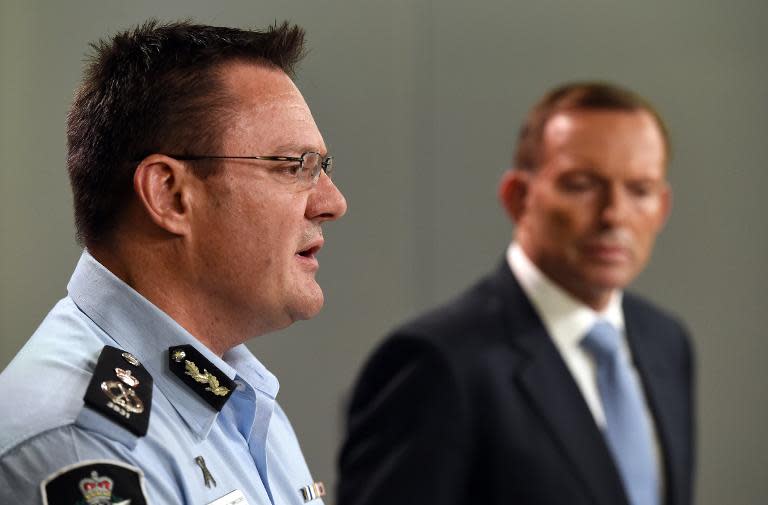 Australian Federal Police deputy commissioner Michael Phelan (L) speaks to the media alongside Prime Minister Tony Abbott in Sydney on April 18, 2015 after two men were arrested in Melbourne for allegedly planning an IS-inspired terrorist attack