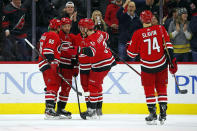 Carolina Hurricanes' Justin Williams (14) second left, is congratulated on his goal against the Winnipeg Jets by teammates Teuvo Teravainen (86), of Finland, Sebastian Aho (20), of Finland, Andrei Svechnikov (37), of Russia, and Jaccob Slavin (74) during the first period of an NHL hockey game in Raleigh, N.C., Tuesday, Jan. 21, 2020. (AP Photo/Karl B DeBlaker)