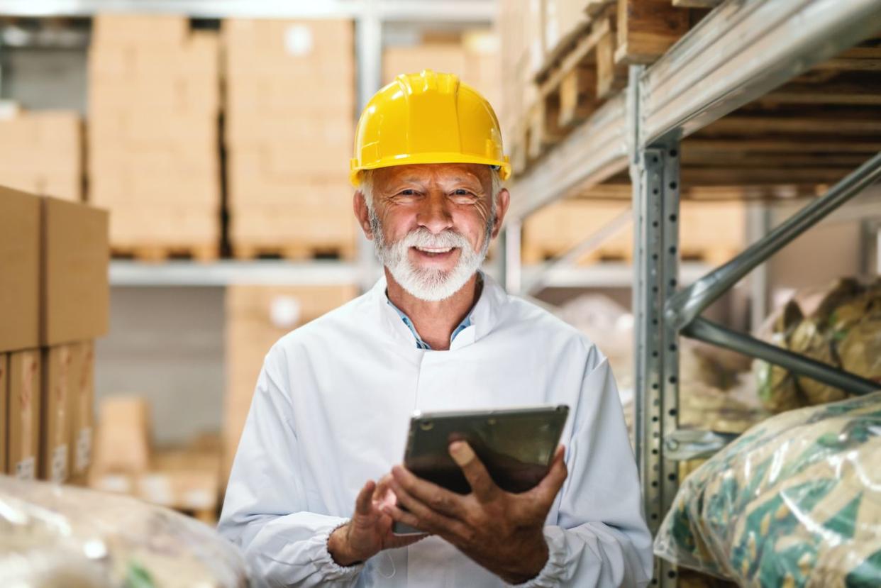 elderly man working in warehouse