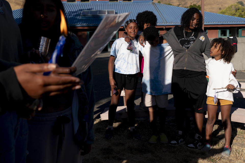 A Havdalah candle is lit as campers sing in a circle at the end of the second week of Camp Be'chol Lashon, a sleepaway camp for Jewish children of color, Saturday, July 29, 2023, in Petaluma, Calif., at Walker Creek Ranch. (AP Photo/Jacquelyn Martin)