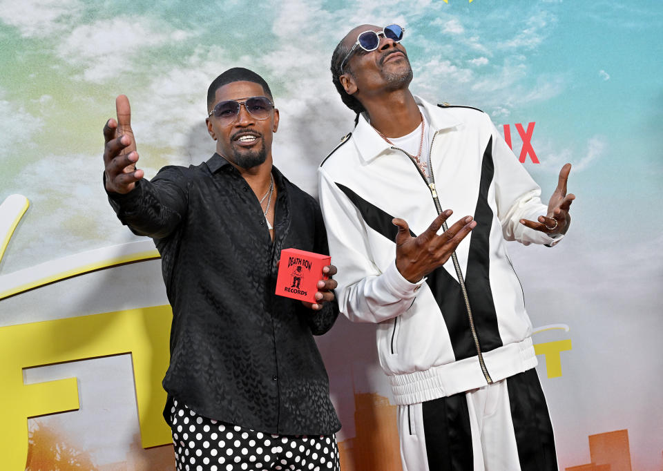 <p>Jamie Foxx and Snoop Dogg live it up at the Los Angeles premiere of <em>Day Shift</em> on Aug. 10.</p>